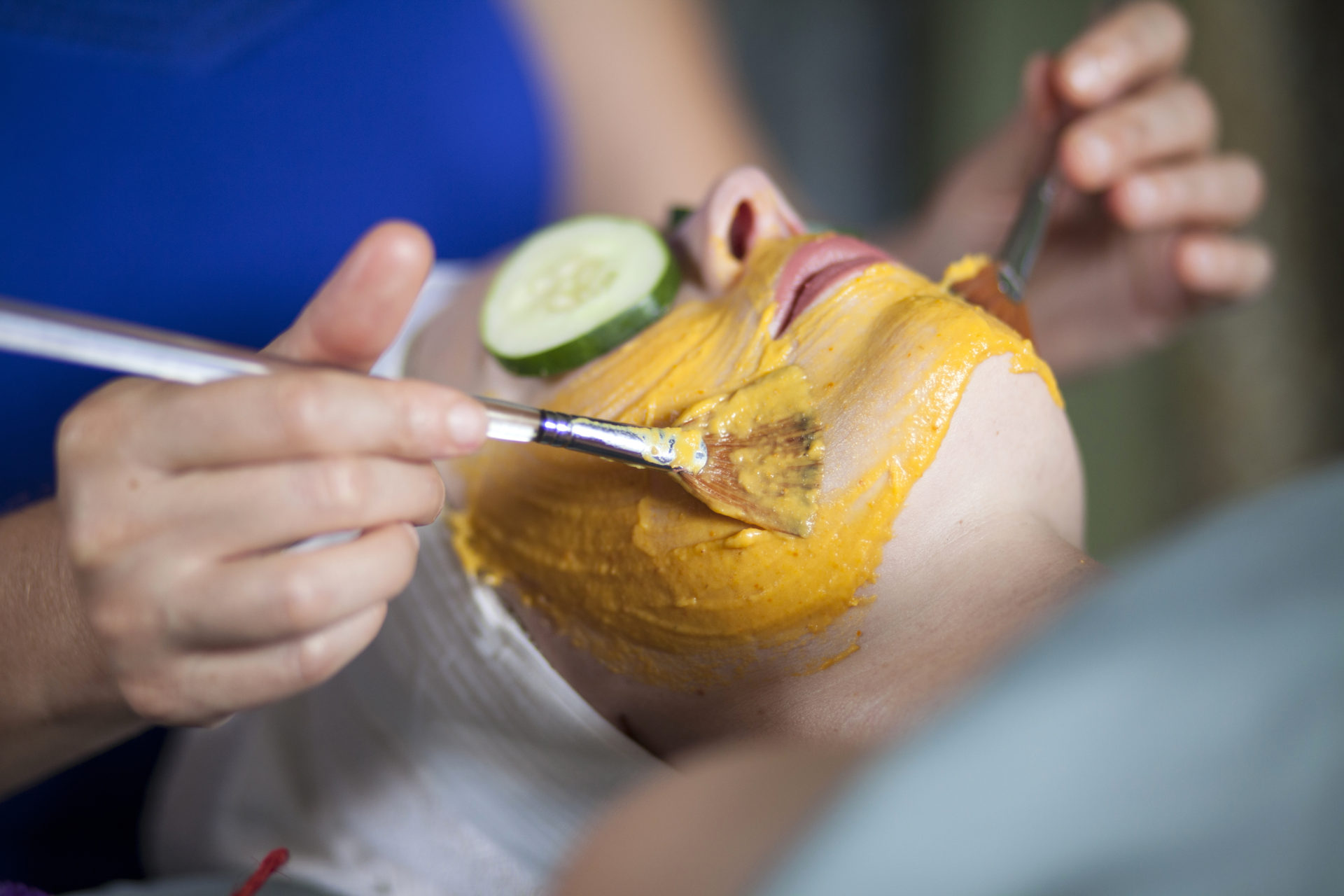 Sarah Becker skin care & massage - Sarah giving facelift with yellow mask, cucumbers